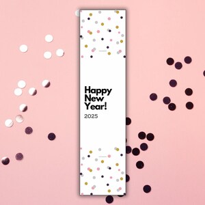 May include: A white card with black text that reads "Happy New Year! 2025" surrounded by pink and black confetti.