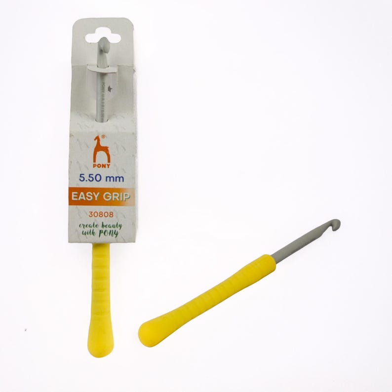 May include: A yellow and gray crochet hook with an easy grip handle. The packaging shows the brand "PONY" and the size 5.50 mm. The text "EASY GRIP" is also visible on the packaging. The hook is designed for creating beauty with PONY.