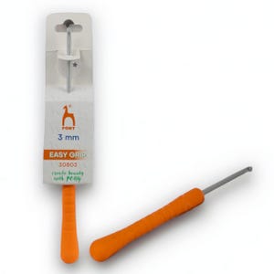 May include: An orange and silver crochet hook with an easy grip handle. The packaging reads "PONY 3 mm EASY GRIP" and "create beauty with PONY". The hook is approximately 5.5 inches long.