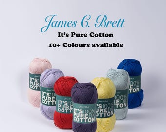 May include: James C. Brett It's Pure Cotton yarn balls in various colors including pink, lavender, red, dark purple, yellow, light blue, and royal blue. Each ball features a label with the text It's Pure Cotton and 10+ Colours available.