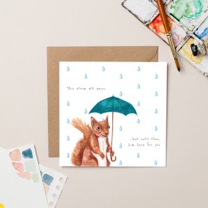 Écureuil avec une carte parapluie
