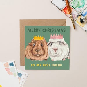 Carte Meilleur ami de Noël avec un cochon d'Inde et une feuille d'or