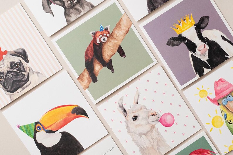 May include: A set of nine greeting cards featuring watercolour illustrations of various animals wearing party hats. The animals include a pug, a red panda, a cow, a llama, a toucan, a parrot, and a dog.