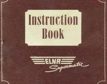 May include: A vintage instruction book with a brown cover and white border. The title "Instruction Book" is in a rectangular cream-colored box. The logo "ELNA Supermatic" is below the title.
