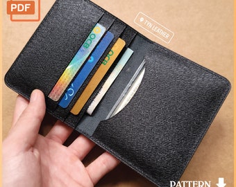May include: Black leather wallet with multiple card slots and a cash pocket. The wallet is open and shows several cards inside.
