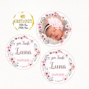 May include: Three round pink and green floral themed stickers with the text "zur Taufe Luna 04.09.2021". One sticker features a baby girl sleeping in a pink floral wreath.