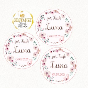 May include: Three round pink and white floral wreath stickers with the text "zur Taufe Luna 04.09.2021" in brown lettering.