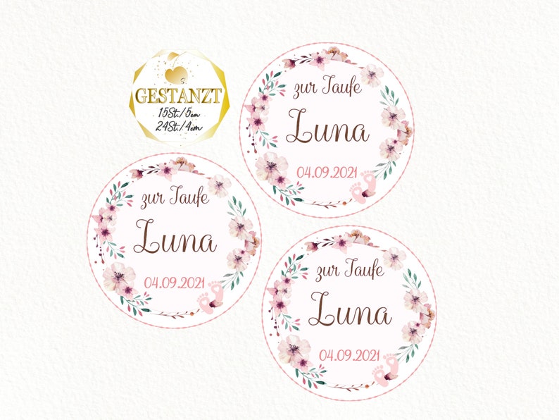 May include: Three round pink and white floral wreath stickers with the text "zur Taufe Luna 04.09.2021" in brown lettering.