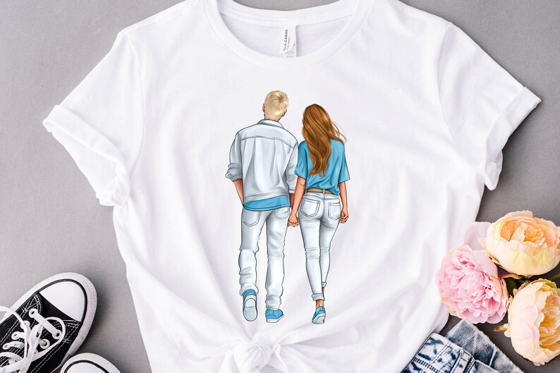 May include: White t-shirt with a graphic of a couple walking hand-in-hand. The man is wearing a white shirt and jeans, and the woman is wearing a blue shirt and jeans.