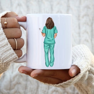 May include: White ceramic mug with a graphic of a woman wearing teal scrubs and holding a clipboard. The woman is facing away from the viewer.