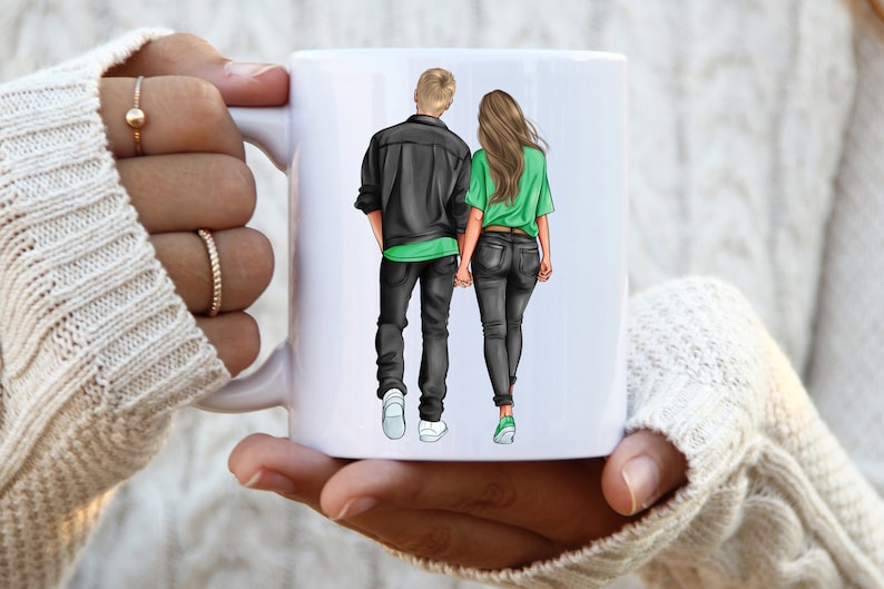 May include: White ceramic mug with a graphic of a couple walking hand-in-hand. The man is wearing a black jacket and jeans, and the woman is wearing a green shirt and jeans.