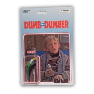 Pode incluir: Uma figura de ação Dumb and Dumber em embalagem blister com um pássaro Petey. A arte do cartão mostra uma pessoa jovem com uma camisa listrada e uma jaqueta cinza, com o texto Petey e Dead Alive impresso na frente do cartão.