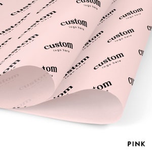 May include: Pink wrapping paper with a repeating pattern of the text "custom logo here" in black.