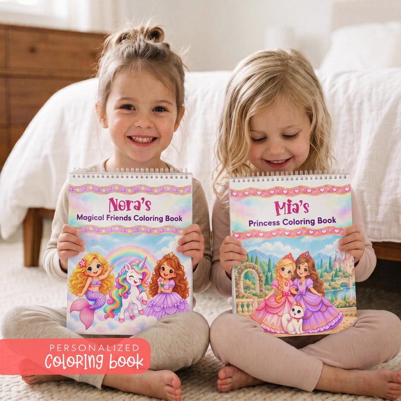 May include: Two spiral-bound coloring books with personalized covers. One reads Nora's Magical Friends Coloring Book featuring a mermaid, unicorn, and princess. The other reads Mia's Princess Coloring Book showing two princesses and a cat.