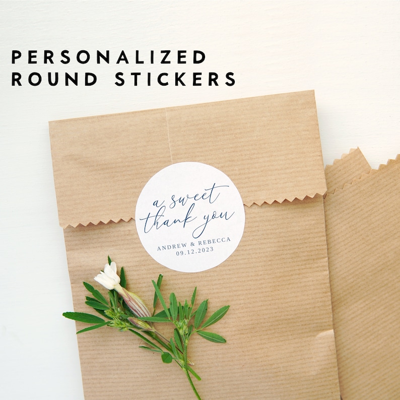 May include: A white round sticker with the text "a sweet thank you" in blue script. Below the text is "ANDREW & REBECCA 09.12.2023" in smaller blue text.