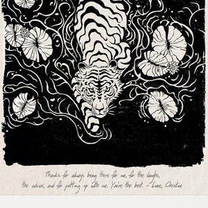 May include: Black and white art print of a tiger swimming among lily pads. The tiger has distinctive stripes. The print is framed in a light wood frame. Text at the bottom reads "Thanks for always being there for me..." and "MATEUSZOLBRYCHT Art".
