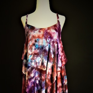 Small ice dye spaghetti strap top with ruffles in purple, blue, and red galaxy design. Pretty tie dye shirt.