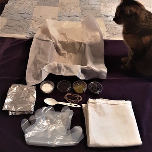 DIY ice dye kit with flour sack tea towel and all supplies to create spiral design with sky blue, red wine, and grape dyes.