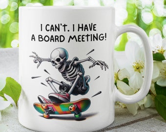 May include: White ceramic coffee mug with a black skeleton skateboarding on a rainbow skateboard. The mug has the text "I can't. I have a board meeting!" printed on it.