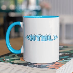 May include: White ceramic mug with a blue rim and handle. The mug features a graphic of the word "HTML" in blue with a frosted ice effect.