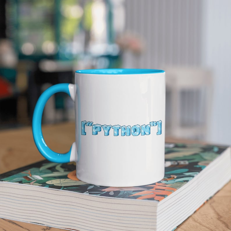 May include: White ceramic mug with a blue rim and handle. The mug has a blue and white pixelated design that says "['PYTHON']" on the front.