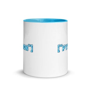 May include: White ceramic mug with a light blue rim. The mug has the text "['PY'" on the right side and "ON']" on the left side, both in a blue, icy font.