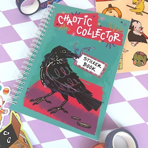 May include: A teal blue spiral bound sticker book with a black crow illustration and the text "CHAOTIC COLLECTOR STICKER BOOK".