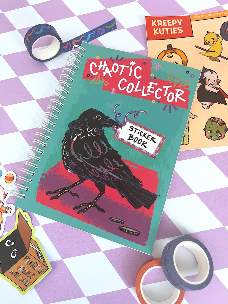 May include: A teal blue spiral bound sticker book with a black crow illustration and the text "CHAOTIC COLLECTOR STICKER BOOK".