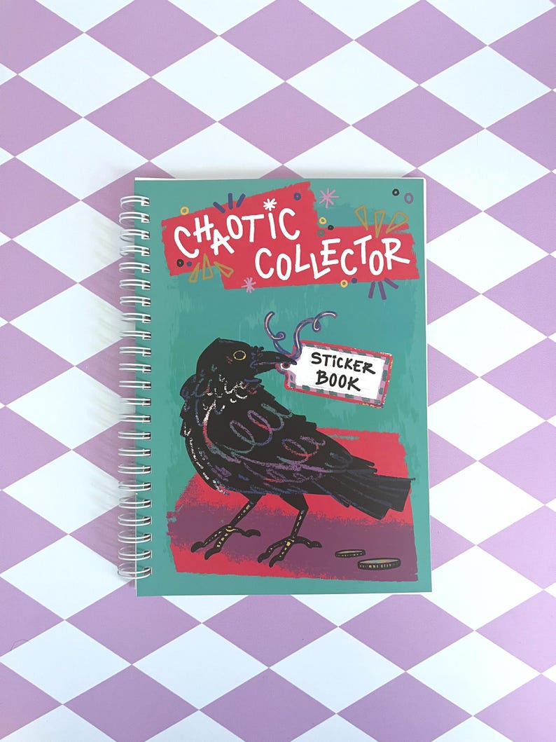 May include: A teal blue spiral bound sticker book with the title "Chaotic Collector" in red and white lettering. A black crow with a red beak is holding a white sticker with the text "Sticker Book" in black lettering.