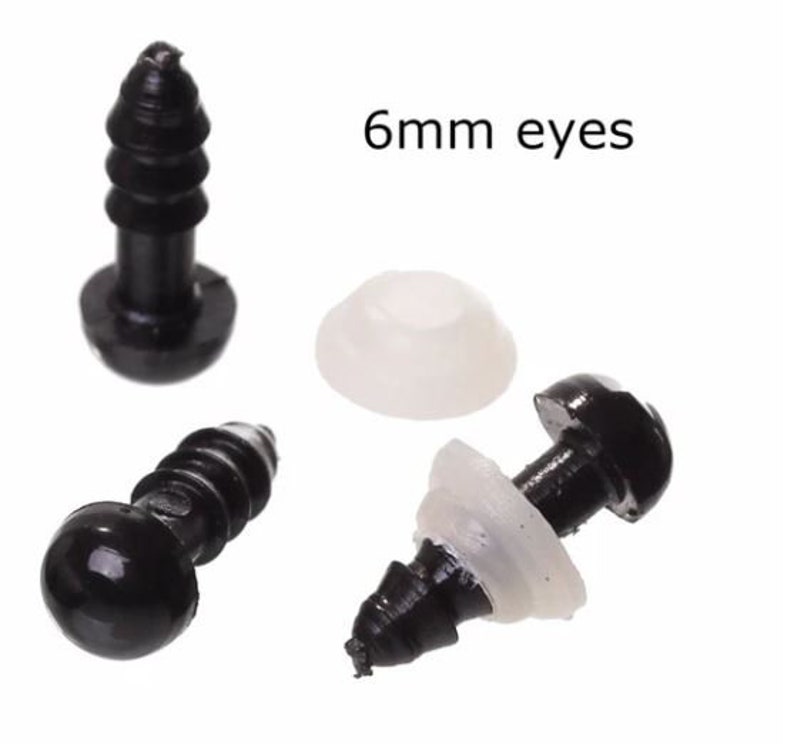 May include: Black plastic safety eyes for crafts, with white backing washers. The image shows several eyes, with the text "6mm eyes". These are small, round eyes for use in stuffed animals, dolls, and other handmade projects.