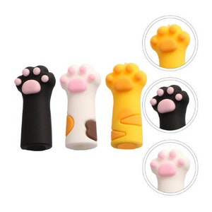May include: Three cat paw-shaped decorative items in black, white, and yellow. Each paw has pink pads and is designed to stand upright. Two additional close-up views of the paw-shaped items are also shown.