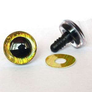 May include: Close-up of three craft supplies: a black and gold eye with a black pupil, a black screw post, and a gold washer. The eye has a clear, iridescent outer ring. These are for toy making.
