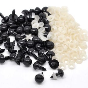 May include: A selection of black plastic safety eyes with screw-on backs and white plastic washers. These craft supplies are used for making soft toys, dolls, and other handmade projects. The eyes are round and shiny.