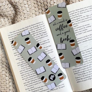 May include: Two green bookmarks with a coffee cup and open book pattern. The text on the bookmark reads "All I need is coffee and a good book."