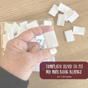 Puede incluir: Una mano sostiene un peque&ntilde;o libro en blanco rectangular blanco. Los libros en blanco est&aacute;n en una bolsa de pl&aacute;stico transparente y esparcidos sobre una superficie de madera. El texto en una etiqueta granate dice "TEMPLATE SIZED TO FIT MY MINI BOOK BLANKS .8 x 1.25 inches" (aproximadamente 2 x 3 cm).