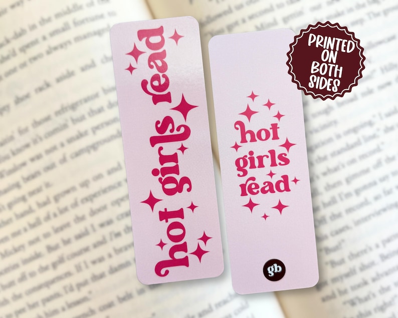 May include: Two rectangular bookmarks with a light pink background and dark pink text. One bookmark features the vertical text 'hot girls read' with star accents. The other displays the same text stacked horizontally with stars and a small 'gb' logo.