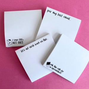 May include: Four white sticky notes with black text. The top note says "per my last email..." The note below it says "I save PDFs NOT LIVES". The note below that says "let's not circle back on this..." The bottom note says "ooh this calls for a spreadsheet!"