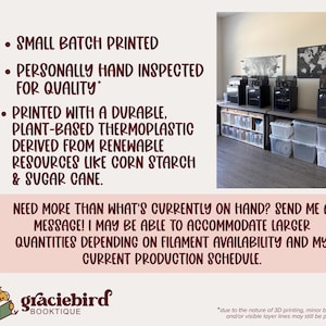 May include: A workspace featuring four black 3D printers on a table with clear storage bins underneath. Text states: SMALL BATCH PRINTED, PERSONALLY HAND INSPECTED FOR QUALITY, PRINTED WITH A DURABLE, PLANT-BASED THERMOPLASTIC, graciebird BOOKTIQUE.