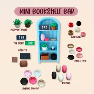 May include: A selection of miniature decorative items, including a blue bookshelf, succulent plants, TBR signs, baskets, low bowls, trinket trays, layering tray sets, and tall vases. The text "MINI BOOKSHELF BAR" is displayed at the top.