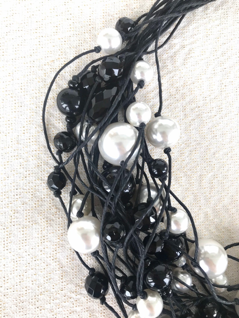 Black waxed cotton multi-row neckline white resin pearls and black crystals