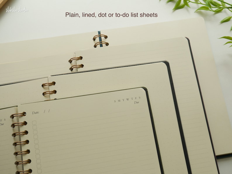 May include: Cream-colored notebooks with spiral binding. The notebooks have lined, dot, or to-do list pages. The text "Plain, lined, dot or to-do list sheets" is visible at the top of the image. The notebooks are open to show the interior pages.