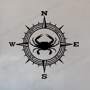 May include: Black compass rose design with a crab in the center. The compass points to North, East, South, and West. The text "HOYT ISLAND TRADING COMPANY" is around the compass.
