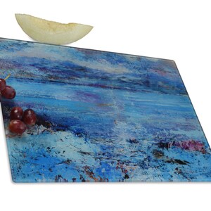 A glass chopping board featuring a painting of the Isle of Mull. Heat resistant it is a worktop saver and worktop protector. It can also be used as a cheese board and as a beautiful centrepiece on table for serving hot and cold food