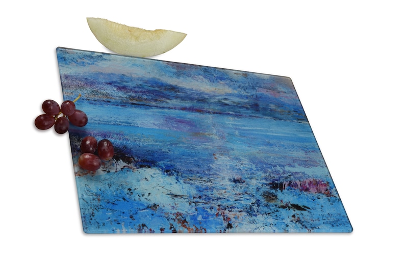 A glass chopping board featuring a painting of the Isle of Mull. Heat resistant it is a worktop saver and worktop protector. It can also be used as a cheese board and as a beautiful centrepiece on table for serving hot and cold food