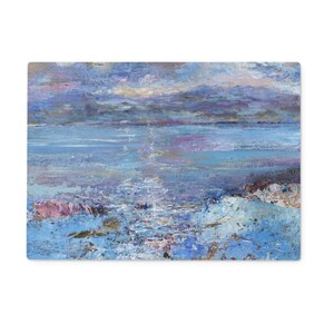 A glass chopping board featuring a painting of the isle of Mull which can be used as a cheese board or as a food serving platter. This worktop saver is made from toughened glass. This Isle of Mull chopping board measures
a generous 39 cms x 29 cms, a perfect size for the kitchen surface or table and is a blend of functionality and artistic design showcasing beautiful, bright toughened glass like stained glass windows that elevate any kitchen space. 