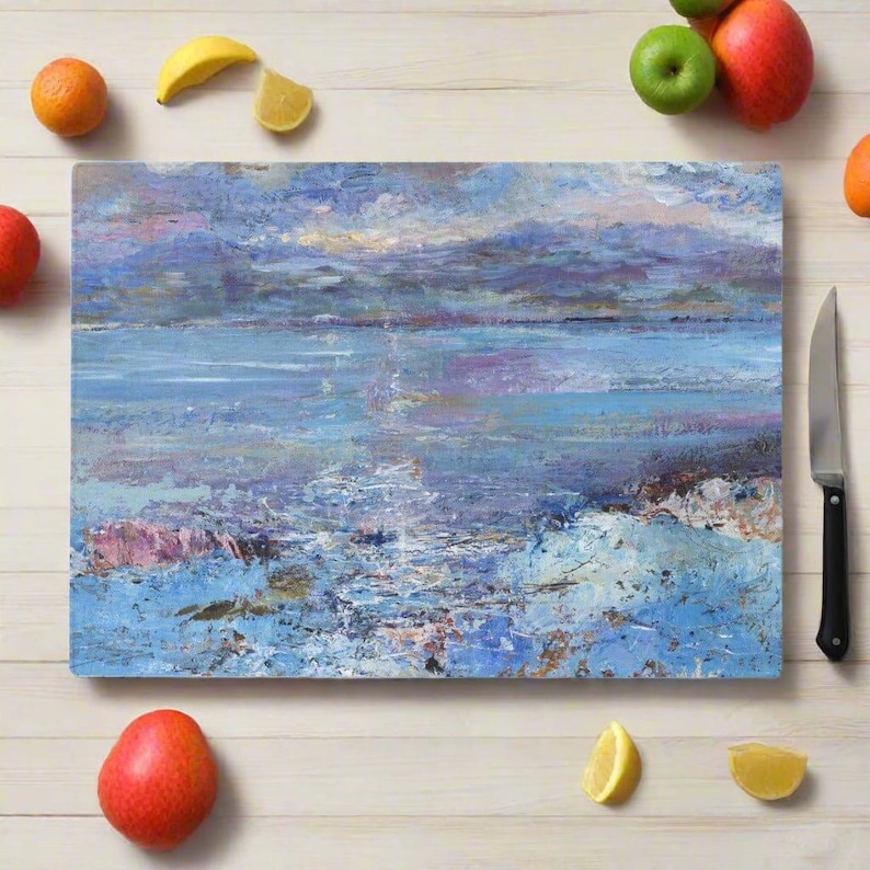 A toughened glass chopping board featuring an seascape of the Isle of Mull.
It can also be an elegant worktop protector and a serving platter. Heat resistant the Isle of Mull chopping board can be used as an oven to table serving platter and as a beautiful centre piece for the table for serving hors d'oeuvres, as a cheeseboard or other treats