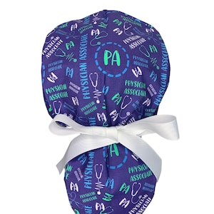 May include: A purple scrub hat with a white ribbon tied around it. The hat is covered in a repeating pattern of the words "Physician Associate" and "PA" in blue, green, and white. A stethoscope is also included in the pattern.