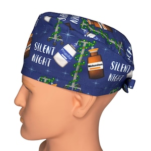 May include: Blue surgical scrub hat with a Christmas-themed print featuring IV poles, medication bottles, and the text "Silent Night".