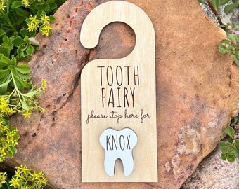 May include: Wooden tooth fairy door hanger with a white tooth cutout and the text "Tooth Fairy please stop here for Knox".