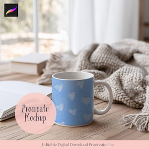 May include: A blue ceramic mug with a white handle and a pattern of white hearts and blue dots. The mug is on a wooden surface next to a book and a blanket. Text on the image says "Procreate Mockup" and "Editable Digital Download Procreate File."